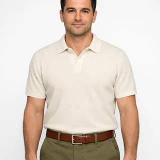 Man in a cream polo, head to waist, arms relaxed at his sides