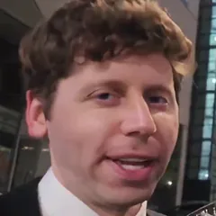 Curly-haired man in a tuxedo and bow tie