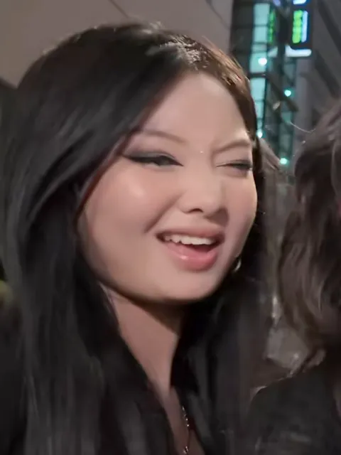 The friend on the left of the group selfie, long straight black hair and a black top